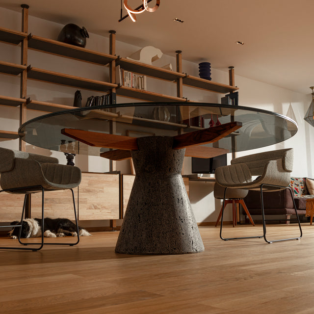 Stricta: Round dining table ideal for 8 to 10 made of Lava Stone, Solid Wood and Smoked laminated Glass.