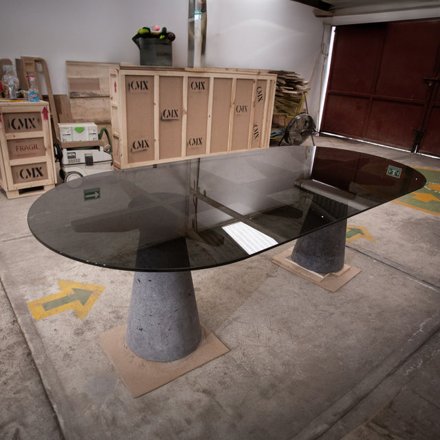 Dining table made of Lava Stone, solid wood and smoked glass