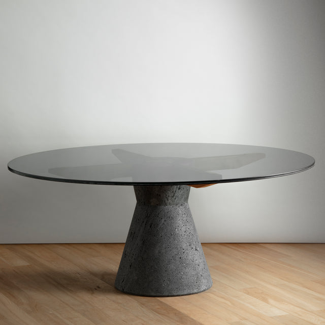 Stricta: Round dining table ideal for 8 to 10 made of Lava Stone, Solid Wood and Smoked laminated Glass.